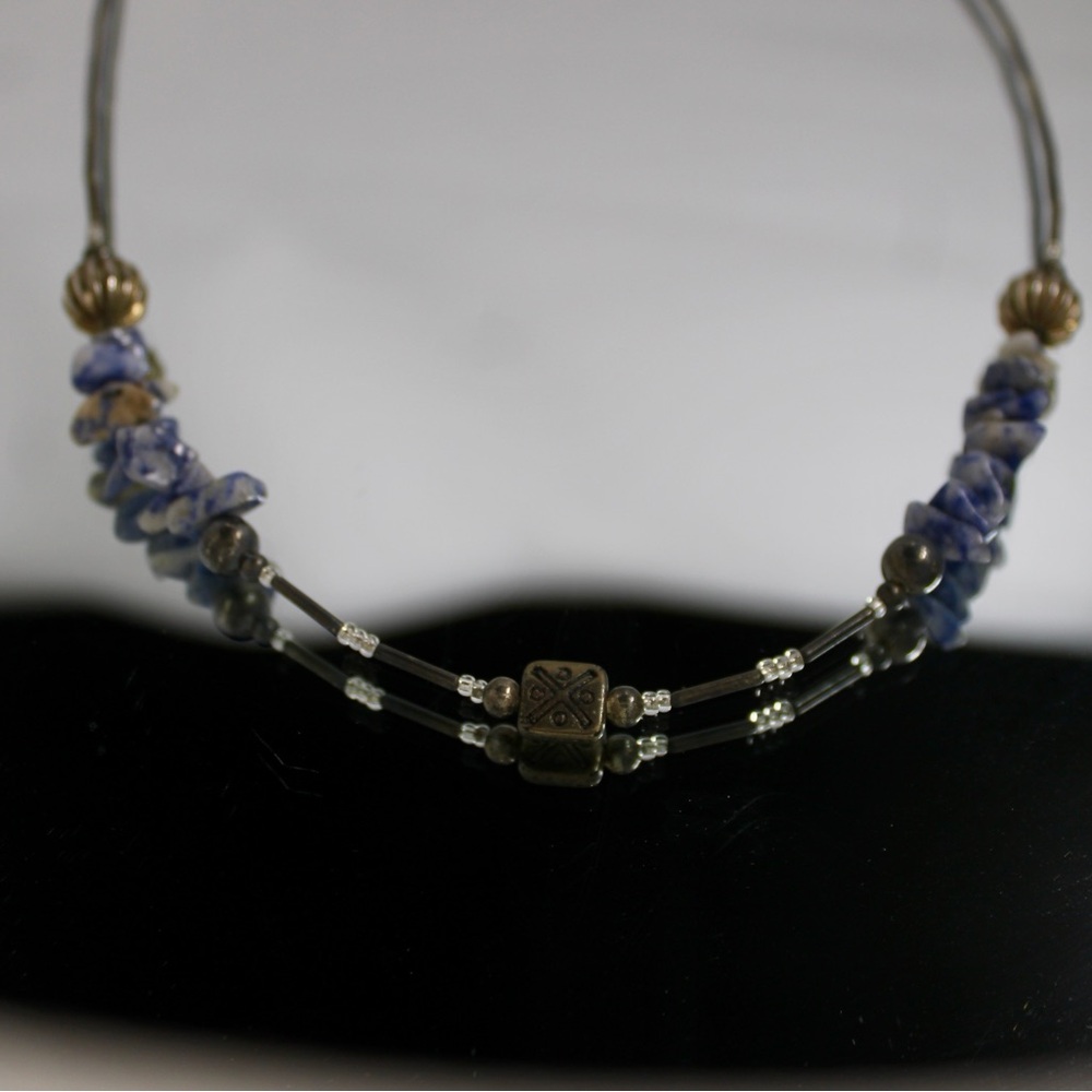 This is a beaded necklace with blue sodalite chips and metal beaded